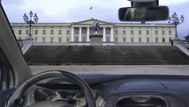Looking through a car windshield with view of the Royal Palace in Oslo, Norway