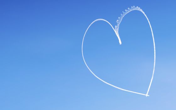 Romantic heart written by an aircraft in the sky, with copy space. Concept for Valentine's day