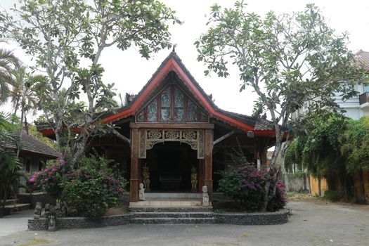 Front view of wooden small house in traditional Indonesian style with terrace. Lombok, Indonesia.