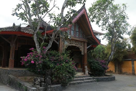 One of the traditional houses that is still preserved in the village. Traditional wooden house in a tropical garden on Lombok island, Indonesia.