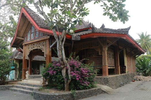 One of the traditional houses that is still preserved in the village. Traditional wooden house in a tropical garden on Lombok island, Indonesia.