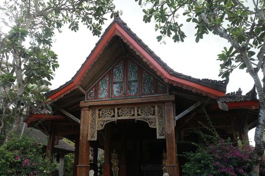 Front view of wooden small house in traditional Indonesian style with terrace. Lombok, Indonesia.