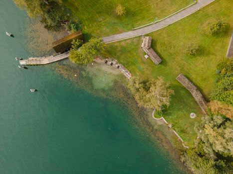 Pier with trees and clean lake. Copy space