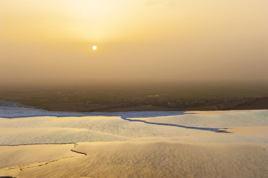 Beautiful vivid sunset over the travertine terraces and pools at Pamukkale, Turkey