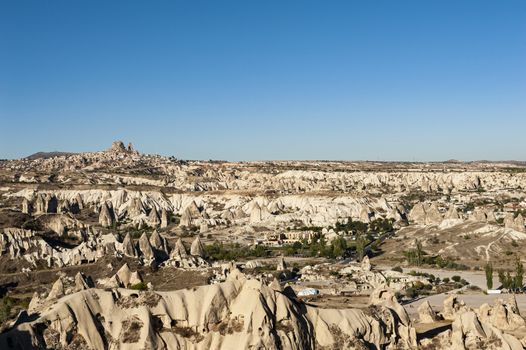 Ancient town and a castle of Uchisar dug from a mountains after sunrise, Cappadocia, Turkey