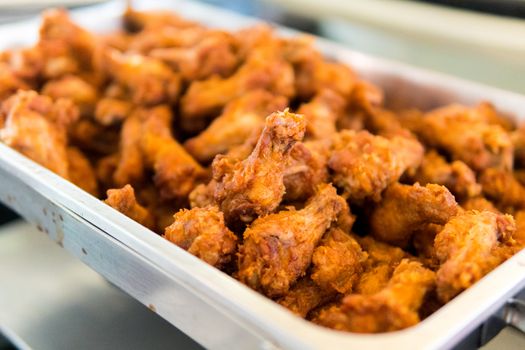 fried chicken wings in stainless tray