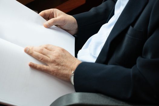 Elderly businessmen are carrying blank documents.