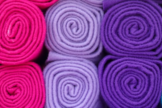 Detailed close up view on samples of cloth and fabrics in different colors found at a fabrics market.