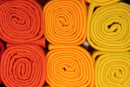 Detailed close up view on samples of cloth and fabrics in different colors found at a fabrics market.