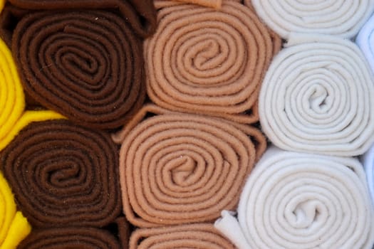 Detailed close up view on samples of cloth and fabrics in different colors found at a fabrics market.