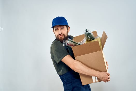 Male worker loading delivery boxes in hands packing lifestyle. High quality photo