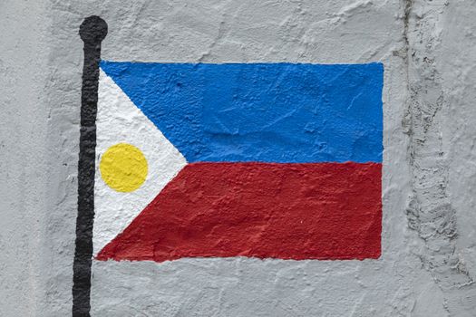 Childish style drawing, of the flag of Philippines, painted on a wall.