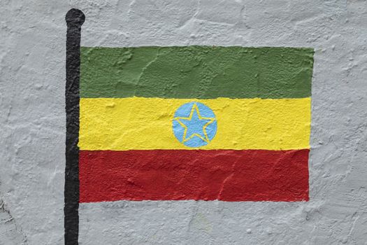 Childish style drawing, of the flag of Ethiopia, painted on a wall.