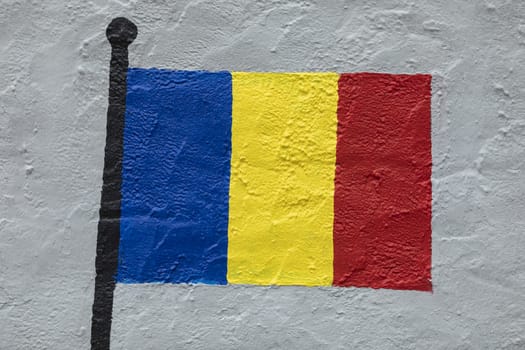 Childish style drawing, of the flag of Romania, painted on a wall.