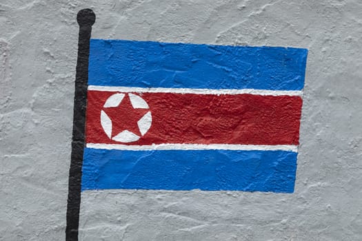 Childish style drawing, of the flag of North Korea, painted on a wall.