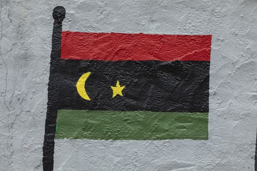 Childish style drawing, of the flag of Libya, painted on a wall.