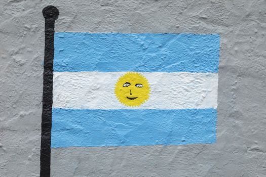 Childish style drawing, of the flag of Argentina, painted on a wall.