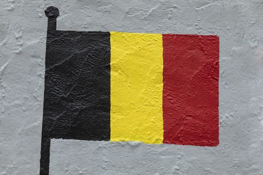 Childish style drawing, of the flag of Belgium, painted on a wall.