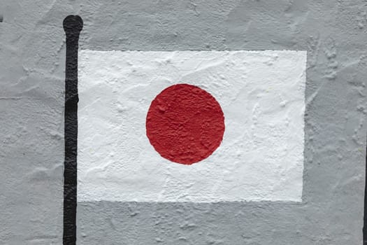 Childish style drawing, of the flag of Japan, painted on a wall.