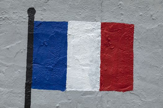 Childish style drawing, of the flag of France, painted on a wall.