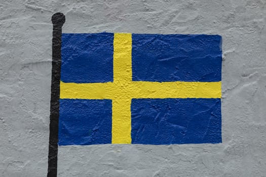 Childish style drawing, of the flag of Sweden, painted on a wall.