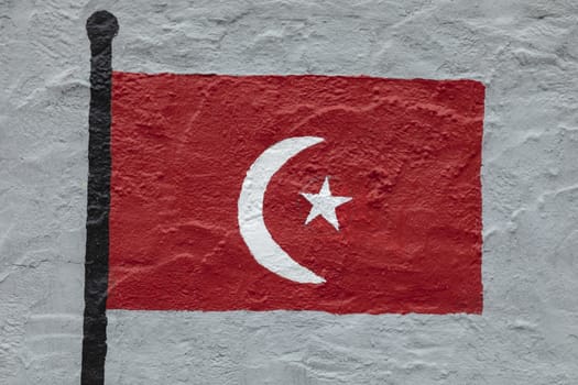 Childish style drawing, of the flag of Turkey, painted on a wall.