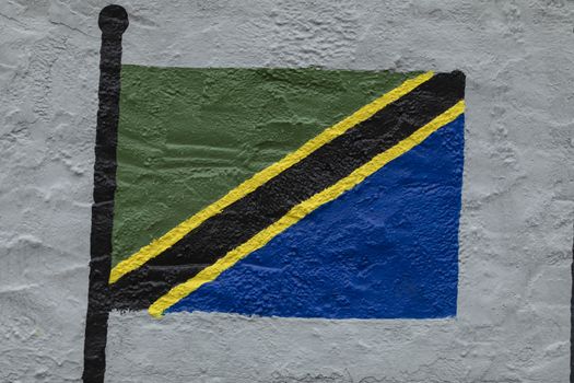 Childish style drawing, of the flag of Tanzania, painted on a wall.