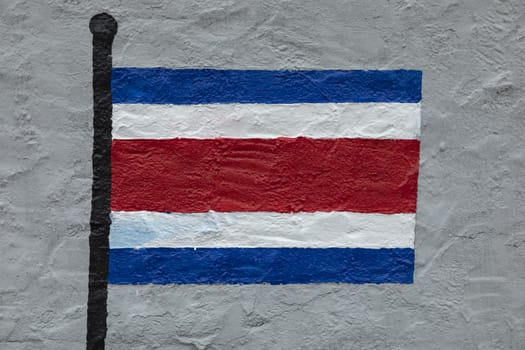 Childish style drawing, of the flag of Costa Rica, painted on a wall.