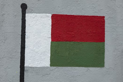 Childish style drawing, of the flag of Madagascar, painted on a wall.