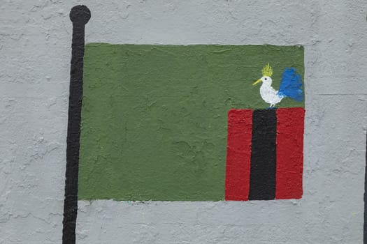 Childish style drawing, of the flag of Zambia, painted on a wall.