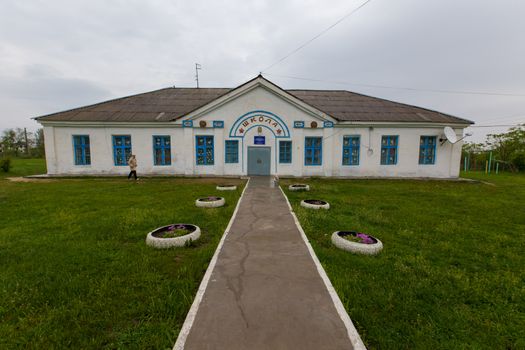 Whitewashed building of an old one-story school in the village.