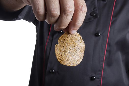 Rye chips in the hand of a male chef