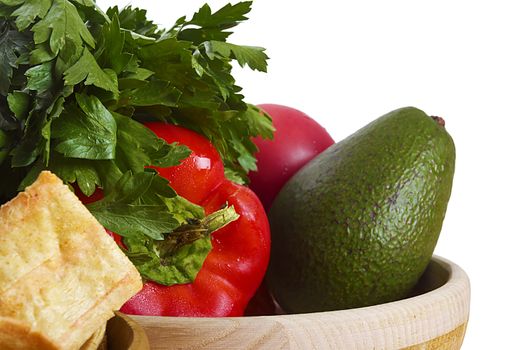 Ingredients for guacamole on white background with a dish of taco chips