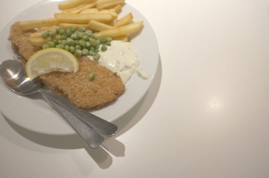 Fish and chips on a dish .