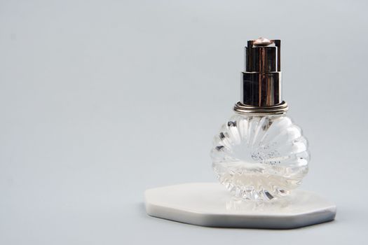 Bottle with aromatic liquid perfume cologne light background. High quality photo