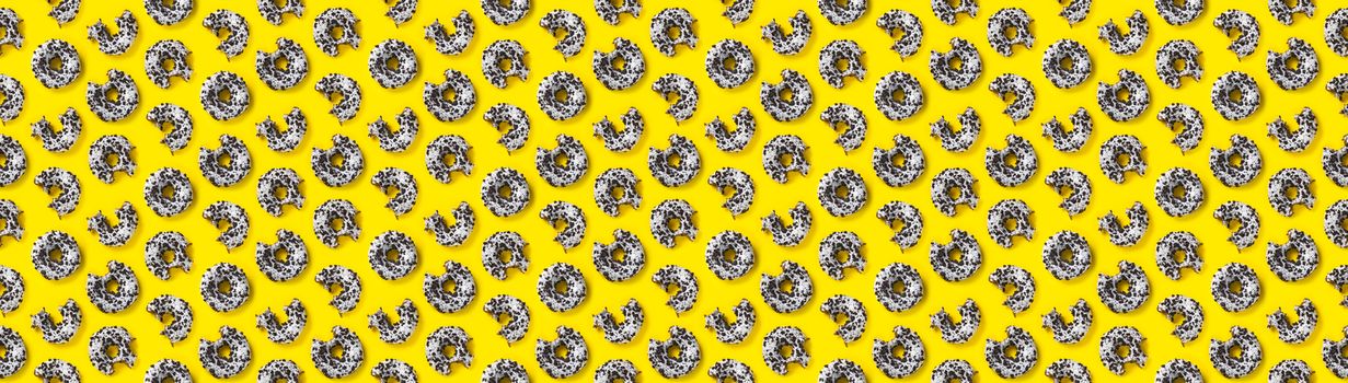 donuts on a yellow banner background top view. Flat lay of delicious nibbled chocolate donuts. used as donut banner or poster background, not pattern