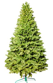 Artificial Christmas green tree without decorations on a metal stand isolated on a white background.