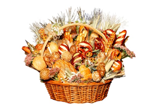 Fresh pastries and bread are beautifully arranged in a wicker basket in the form of a bouquet. Isolated on white background.