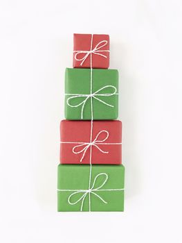 Christmas tree shape from red and green gift boxes on white background. Holiday flat lay.