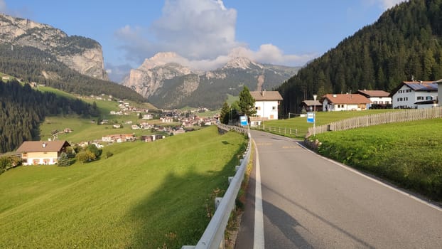 Val Gardena, Italy - 09/15/2020: Scenic alpine place with magical Dolomites mountains in background, amazing clouds and blue sky in Trentino Alto Adige region, Italy, Europe