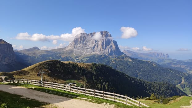 Val Gardena, Italy - 09/15/2020: Scenic alpine place with magical Dolomites mountains in background, amazing clouds and blue sky in Trentino Alto Adige region, Italy, Europe