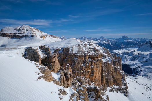 View of a ski resort piste and Dolomites mountains in Italy from Passo Pordoi pass. Arabba, Italy
