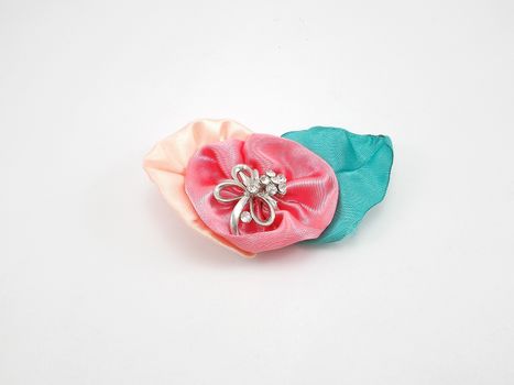 Floral fabric with metal ribbon brooch use as pin during wedding event