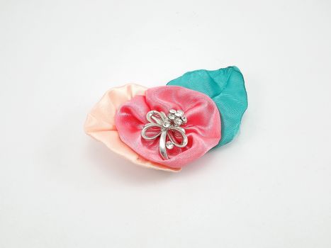 Floral fabric with metal ribbon brooch use as pin during wedding event