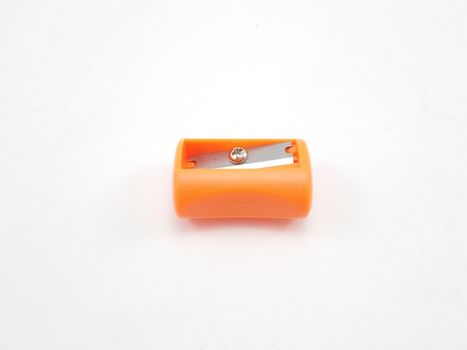 Orange manual hand operated pencil sharpener use to sharpen dull pencils