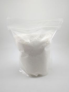 White gentle laundry powder in clear plastic pack use to clean baby fabric clothes 