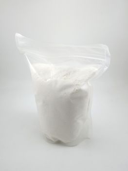White gentle laundry powder in clear plastic pack use to clean baby fabric clothes 
