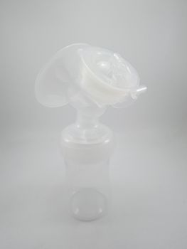 Clear plastic silicone breast pump use for lactating mother