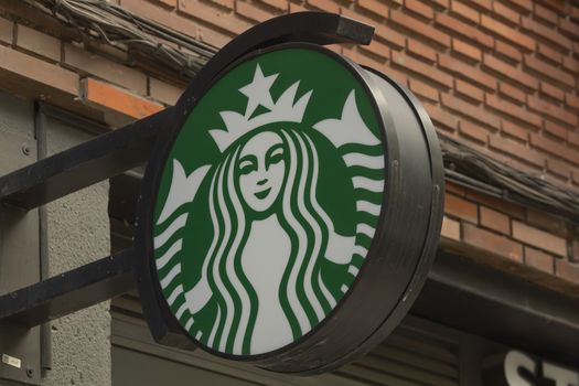 Madrid, Spain - May 19, 2020: The sign located above the entrance area to the Starbucks coffee shop, on Conde de Peñalver street, in the Salamanca district.