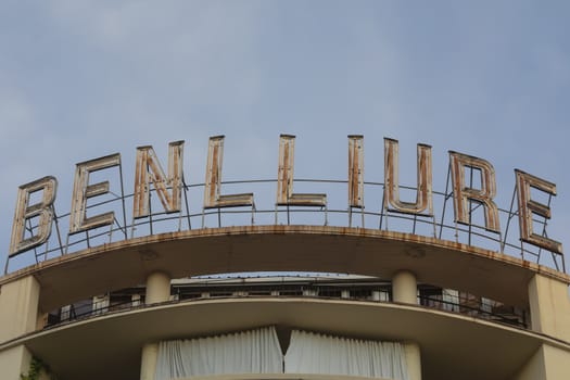 Madrid, Spain - May 19, 2020: The old rusty sign of the Benlliure cinemas, located on the roof of a building, on Alcala street, in the Retiro district.